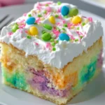 Easy Easter Poke Cake topped with colorful decorations and vibrant frosting.
