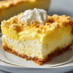 Lemon Cream Cheese Dump Cake baked and served on a plate, garnished with lemon slices.