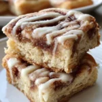 Delicious Cinnamon Roll Bliss Bars topped with icing and cinnamon.