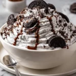 Delicious Oreo Fluff dessert in a bowl, topped with crushed Oreos.