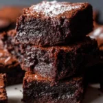 Fudgy cocoa brownies with a rich chocolate glaze on a plate