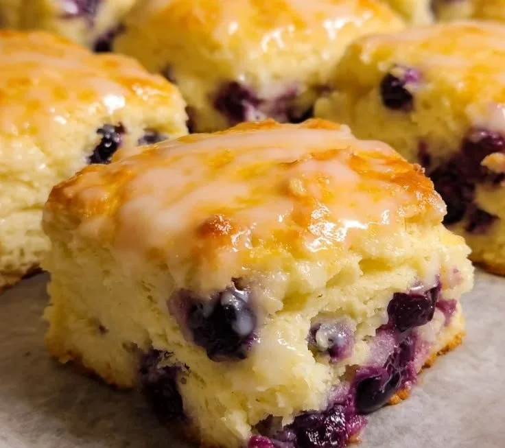 Plate of lemon blueberry butter swim biscuits with fresh blueberries
