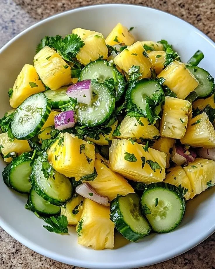 Delicious Pineapple Cucumber Salad served in a bowl with fresh herbs