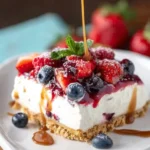 Berries and cream layer dessert with dulce de leche topping