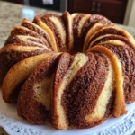 Sliced Cinnamon Swirl Bundt Cake on a plate with a swirl pattern