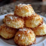 Delicious Lemon Coconut Cheesecake Cookies on a plate with a lemon slice garnish.