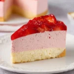 Delicious Strawberry Mousse Cake topped with fresh strawberries and whipped cream